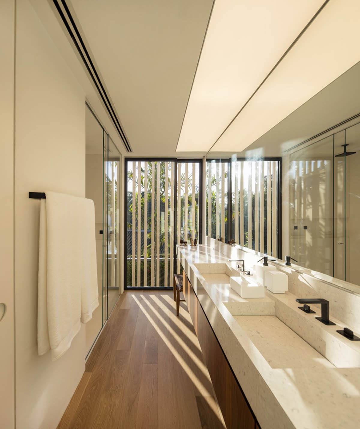 Studio AG designed large wooden residence featuring punctured volumes with gabled roof in São Paulo