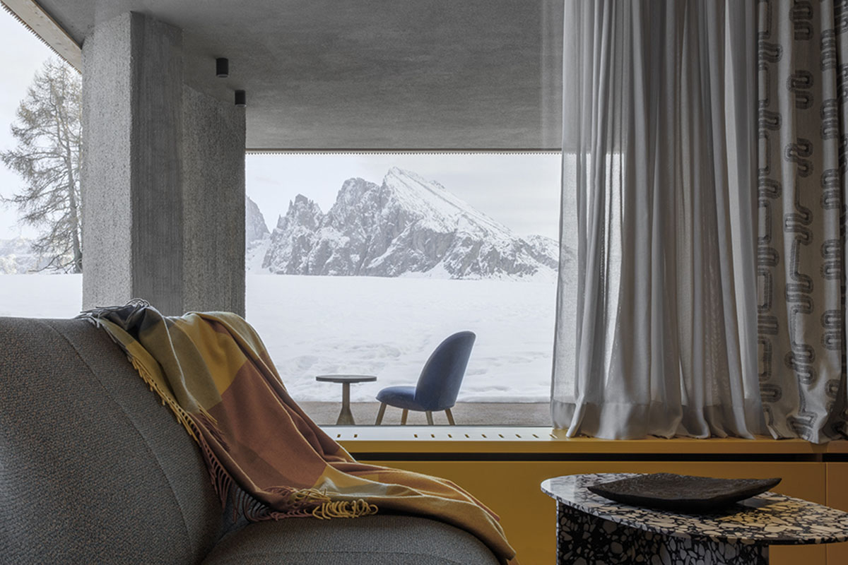 Icaro Hotel featuring wooden colonnade frames embraces alpine heritage landscape in Italy 