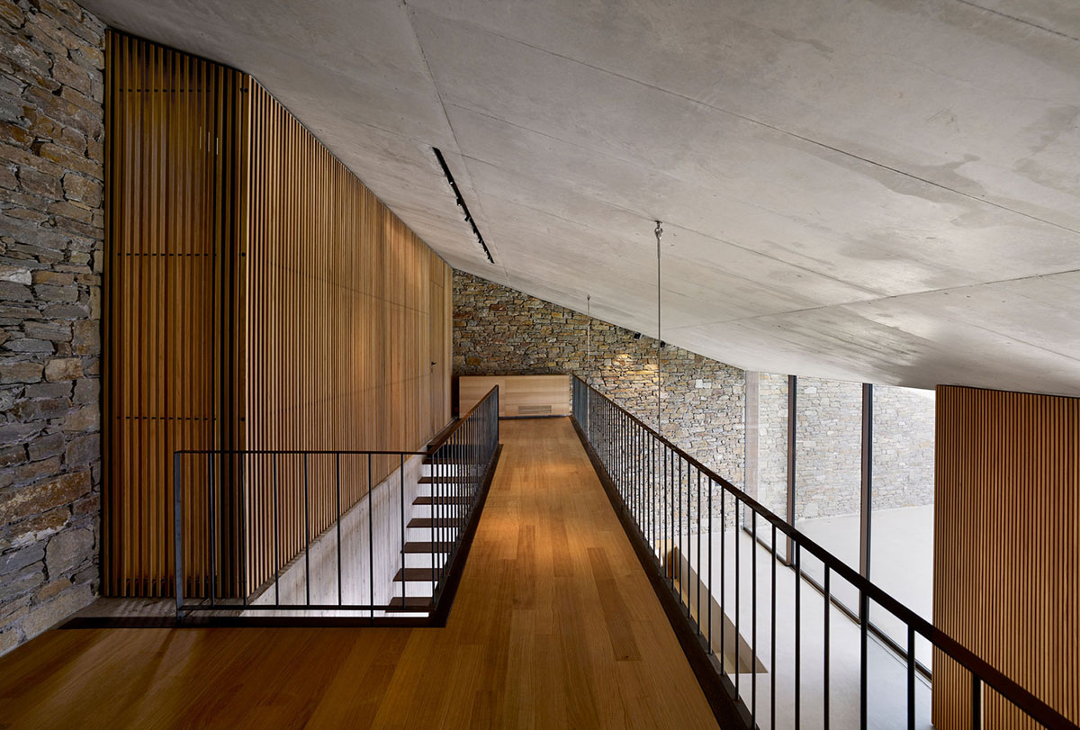 MOLD Architects used advantages of sloping land to design Ncaved house in Greece