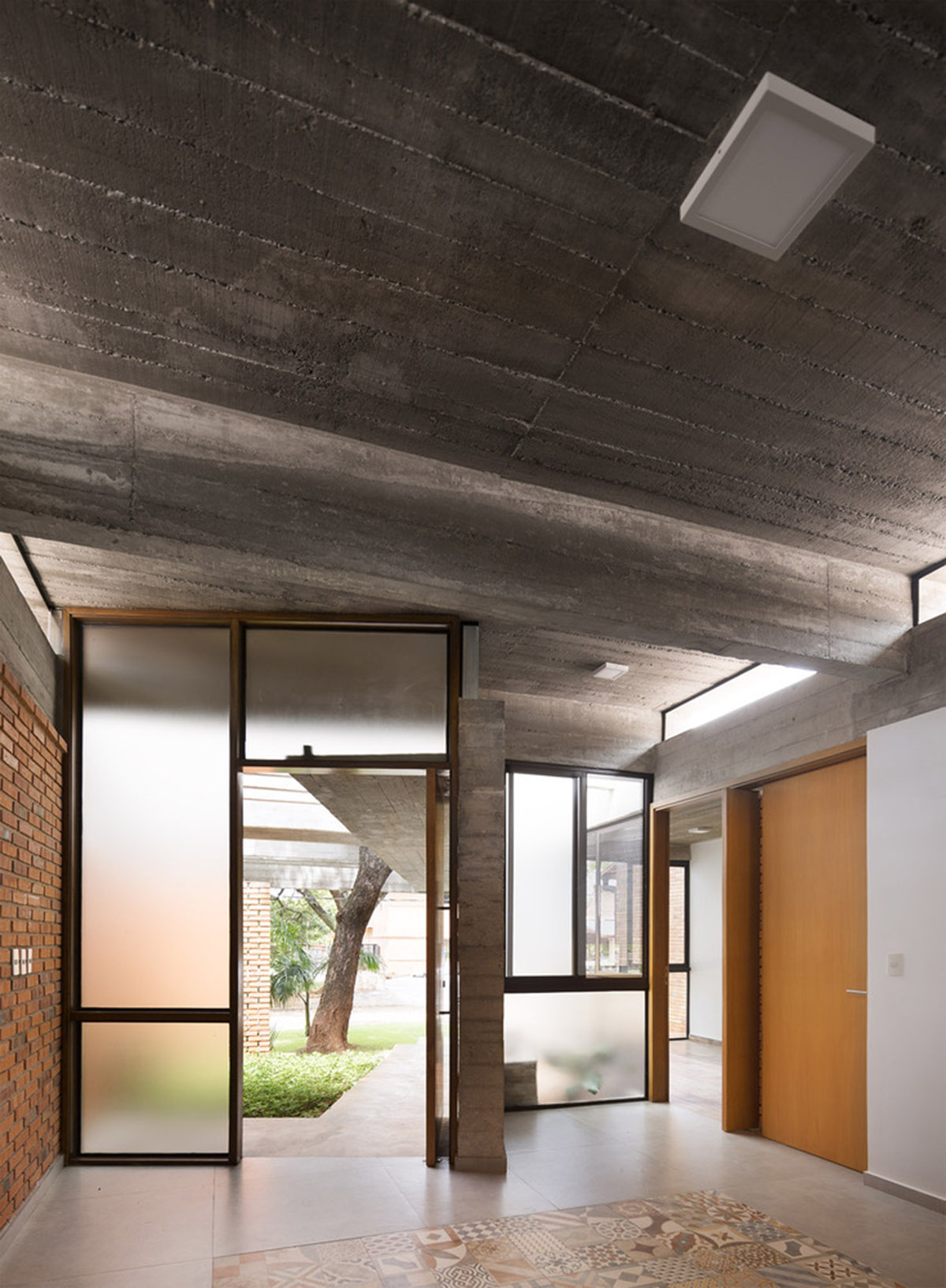Concrete roof slabs and surfaces freely fly over this brick house in Paraguay by Culata Jovái Group