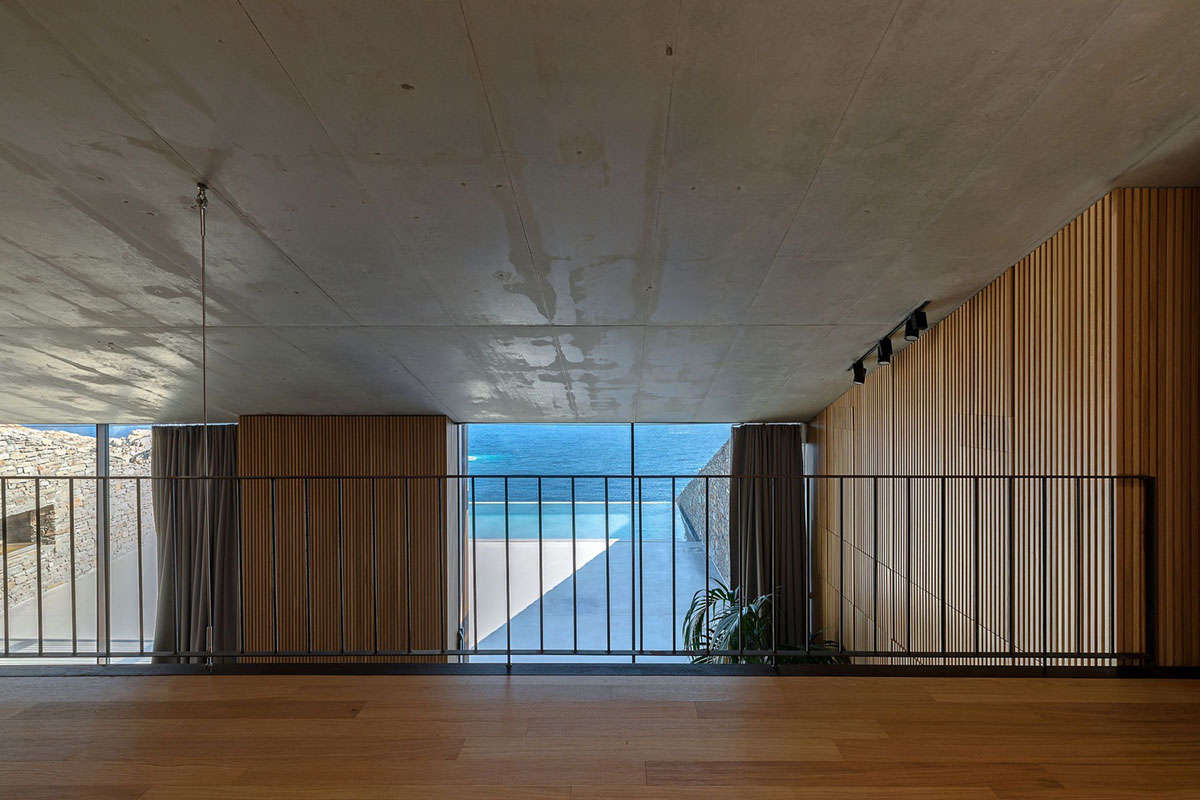 MOLD Architects used advantages of sloping land to design Ncaved house in Greece