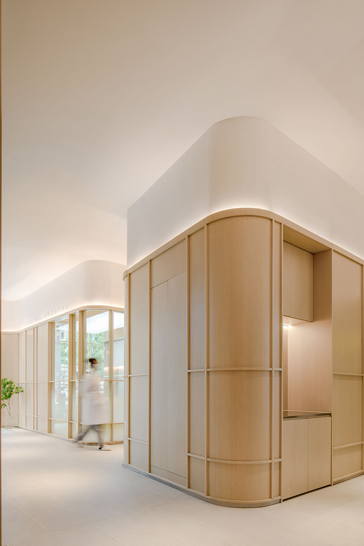 JACKY.W DESIGN completes dental clinic with rounded wooden walls and natural tones in China 