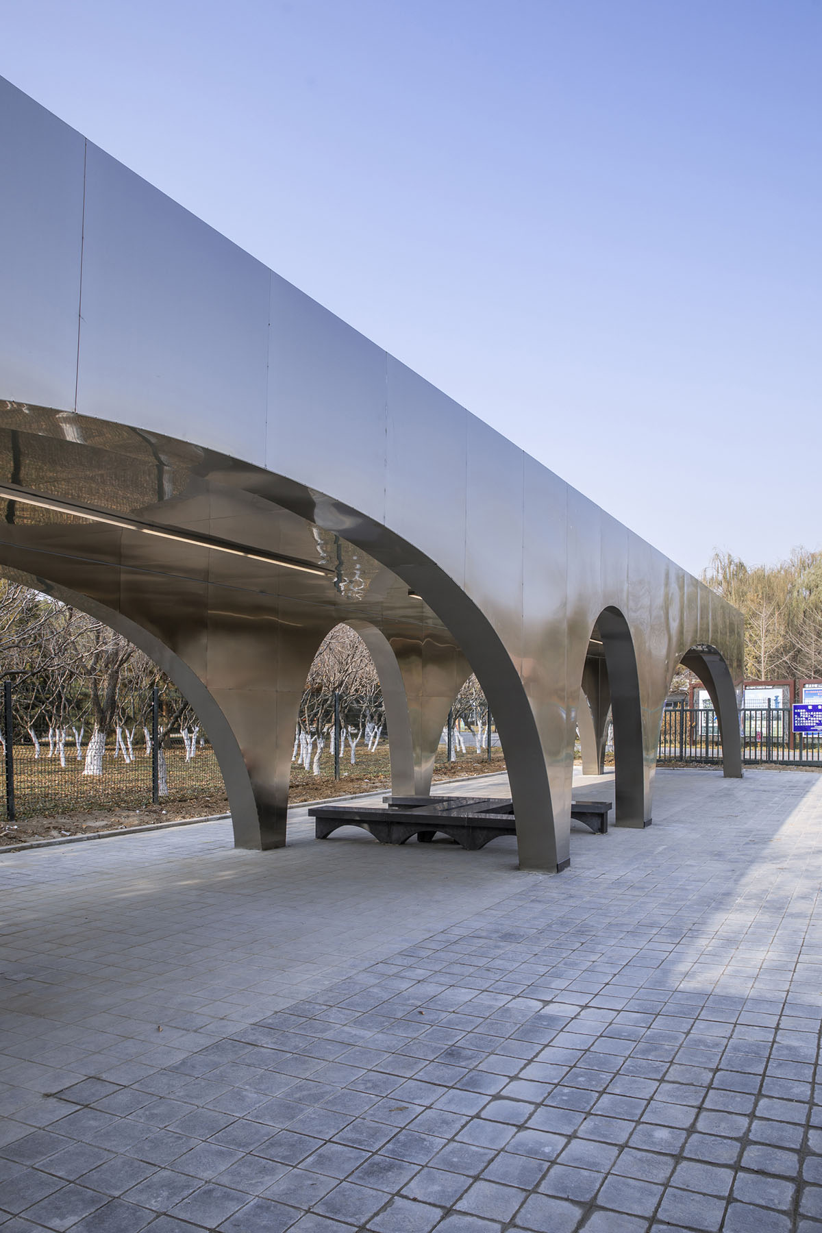 TEMP designs runner's station with stainless steel arcades in Beijing Olympic Forest Park