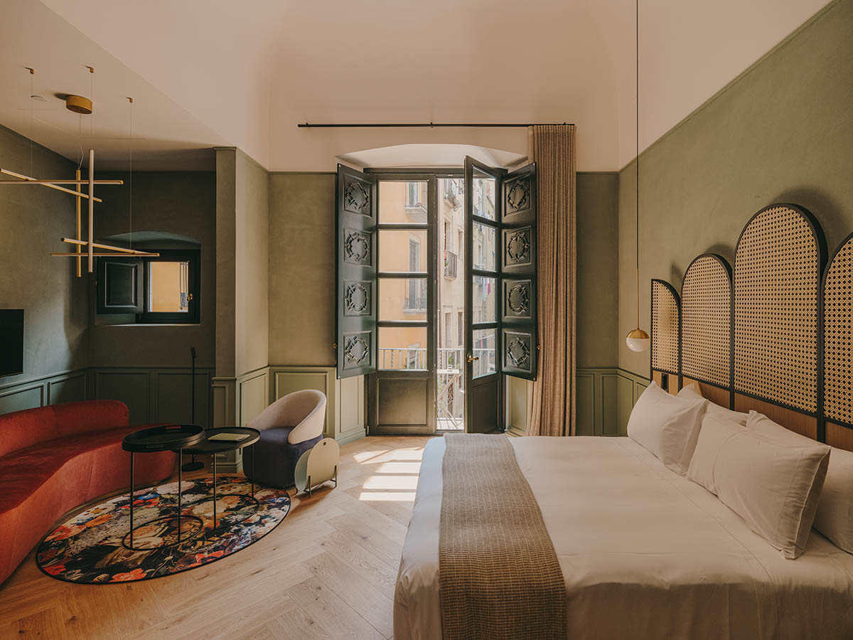 El Equipo Creativo converts 18th-century palace into hotel with rich textures and colors in Girona