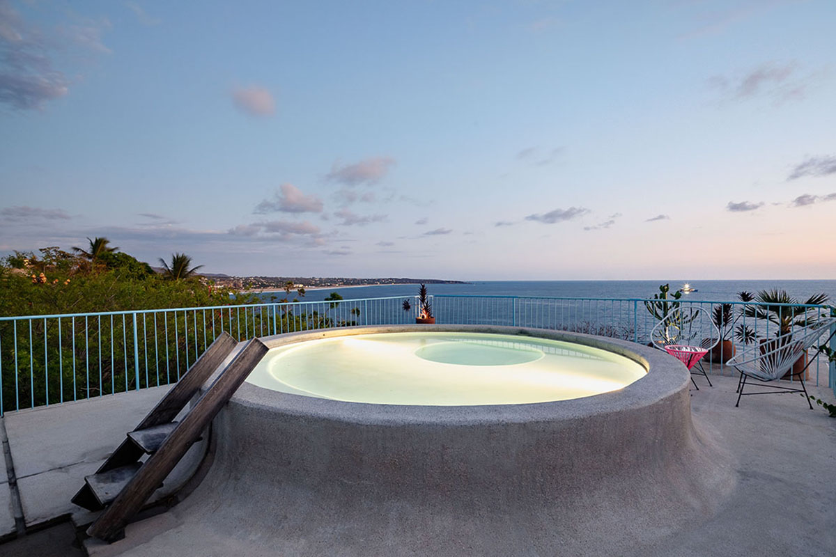 Francisco Pardo Arquitecto's housing features circular  pool overlooking the coastal landscape