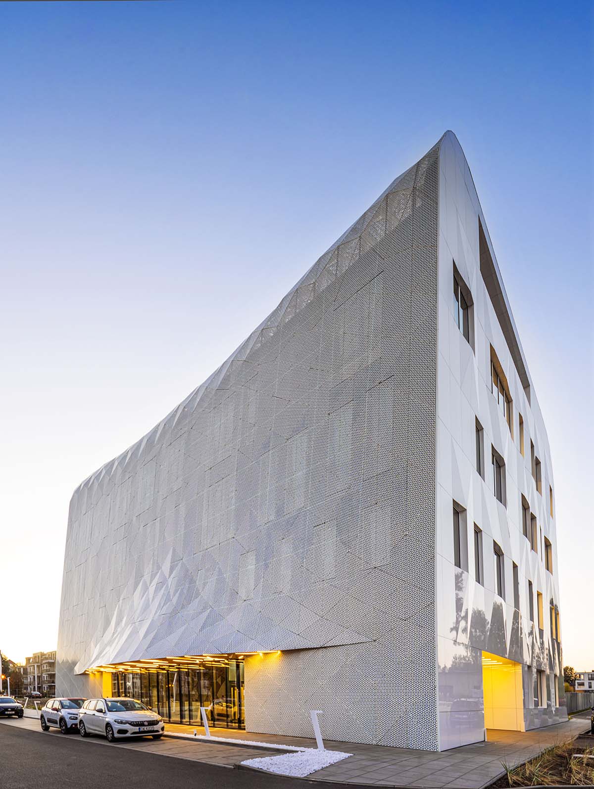 FAAB wraps research center with white perforated facade evoking sea waves in Poland 