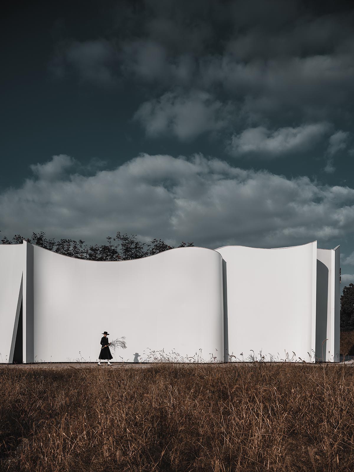 Chinese chapel creates a fluid silhouette featuring curving walls to mimic blossoming petals 