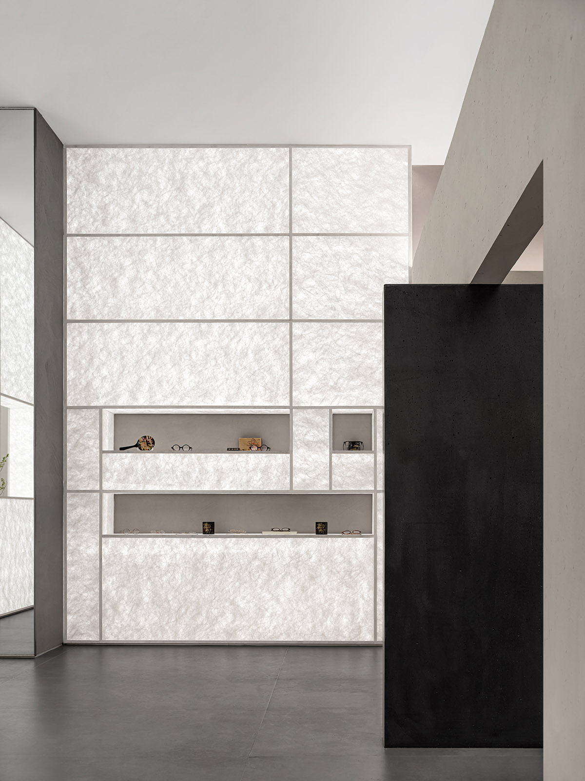 Luminous screen walls create fluid interiors for an optic store designed by Onexn Architects 