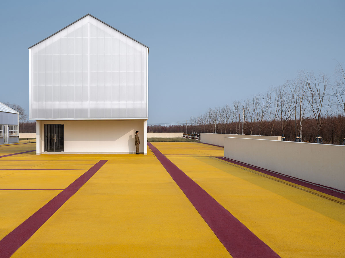 Wutopia Lab converts abandoned barnyard into a golden yellow field resembling a frozen harvest time