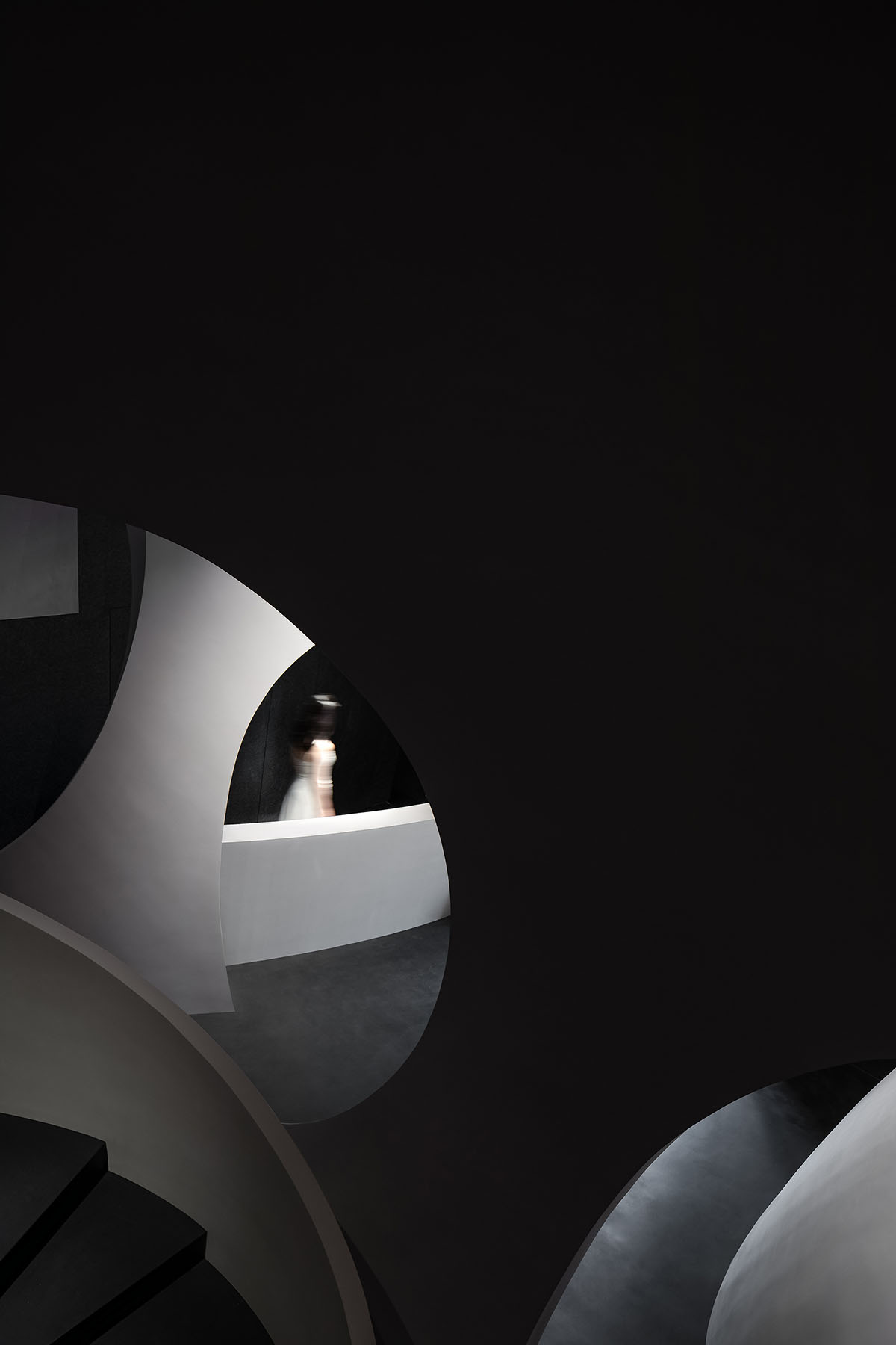 A beauty salon by AD ARCHITECTURE features dark-hued interiors drawing inspiration from cells