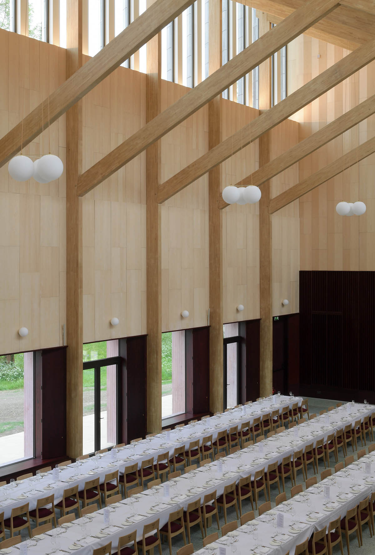 Feilden Fowles completes dining hall wrapped in green faience tiles at University of Cambridge