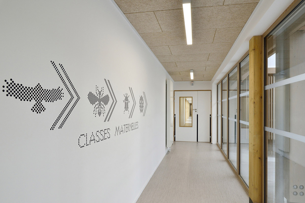 This human-scale school in French town wrapped by different geometry of wood claddings