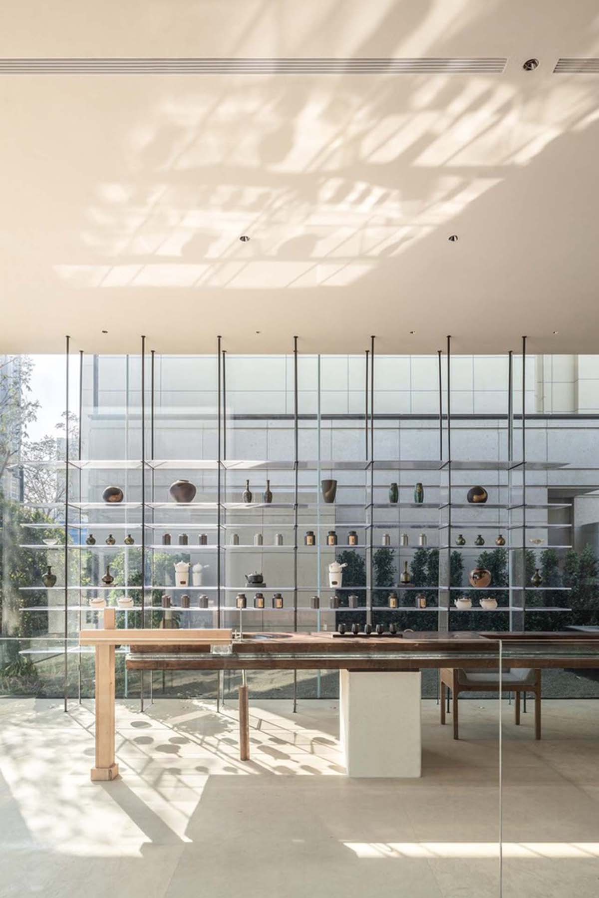 Waterfrom Design creates peaceful interior with wooden furnitures for tea community center in China