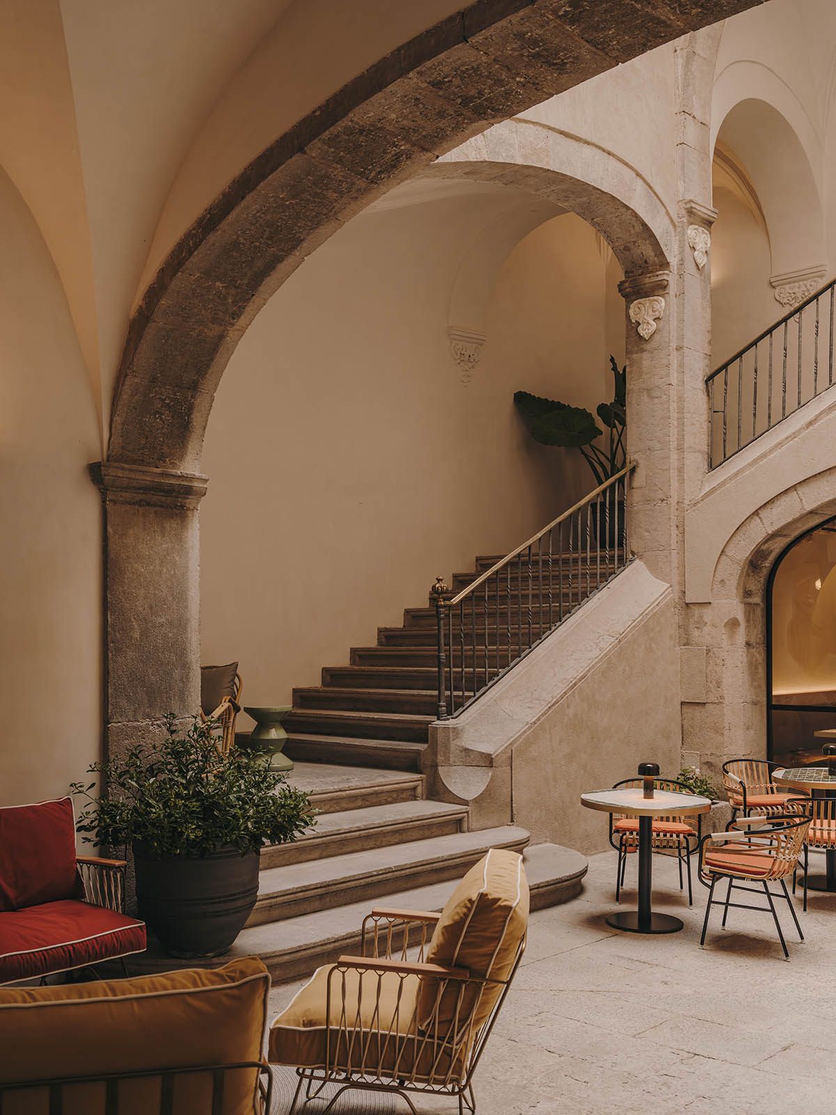 El Equipo Creativo converts 18th-century palace into hotel with rich textures and colors in Girona