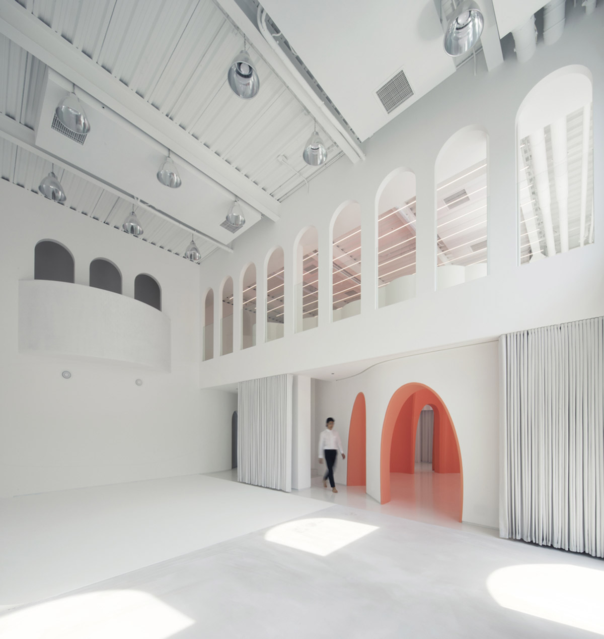 123 architects converts industrial building into photography studio featuring arched addition