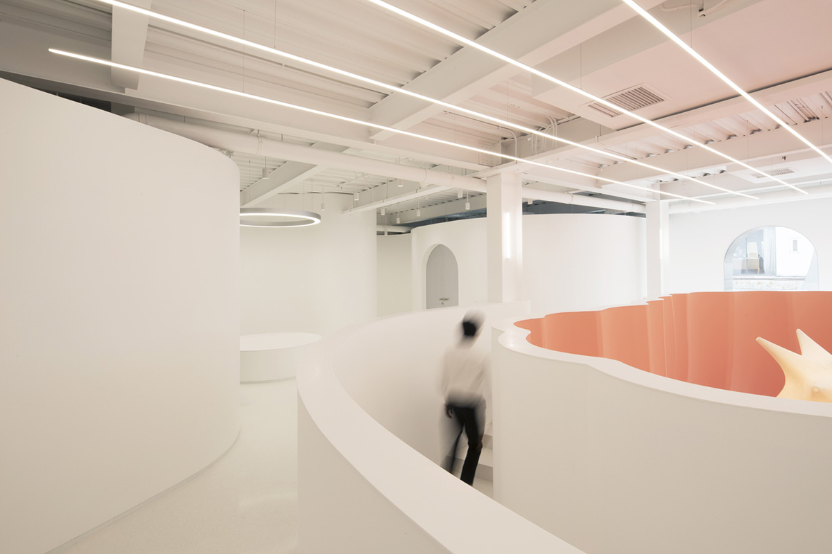 123 architects converts industrial building into photography studio featuring arched addition