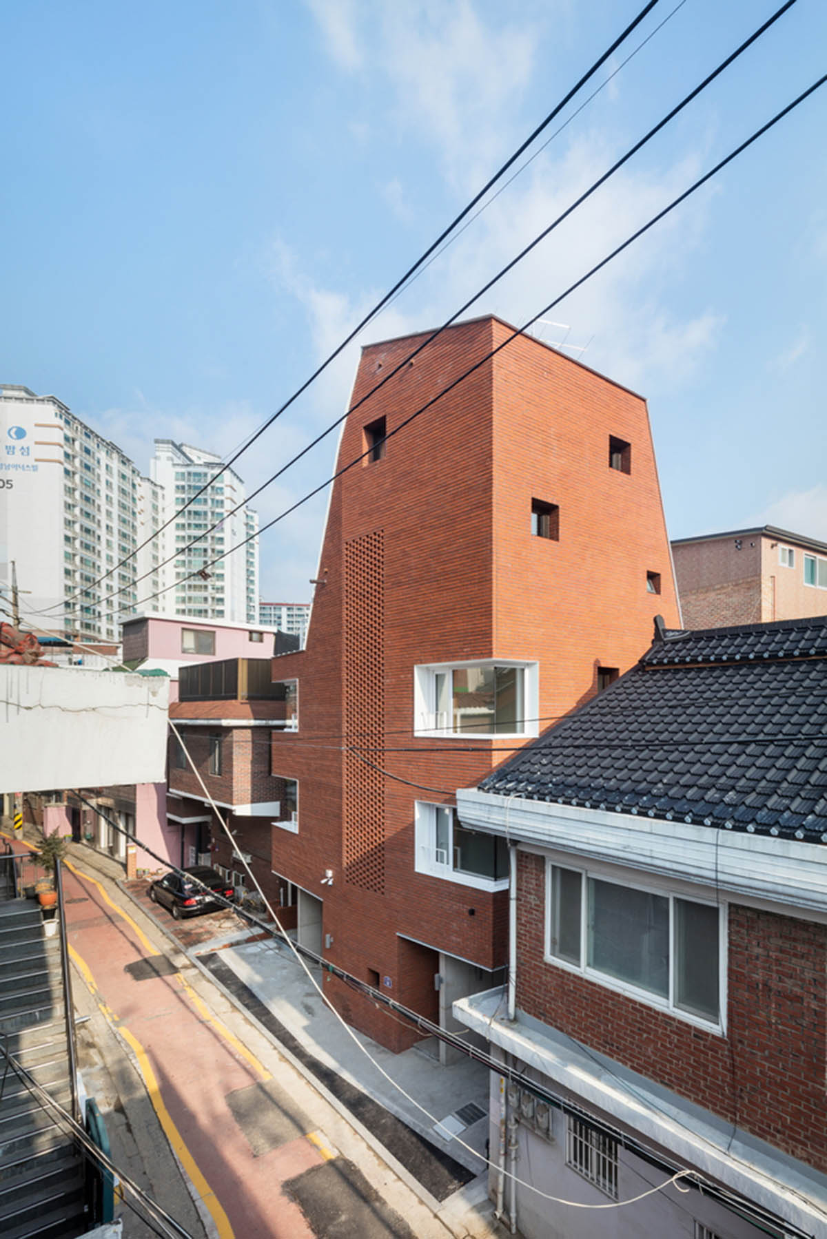 2m2 architects designed clay brick Sista House with inclined roof on narrow lot in Seoul
