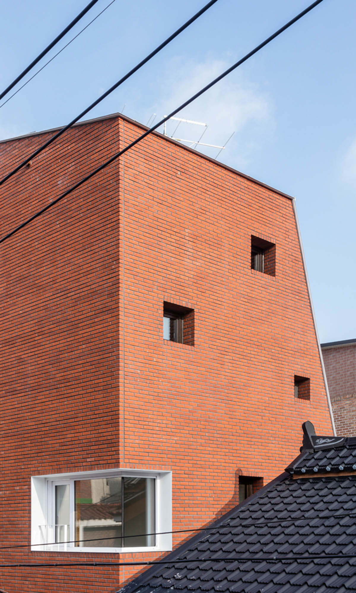 2m2 architects designed clay brick Sista House with inclined roof on narrow lot in Seoul
