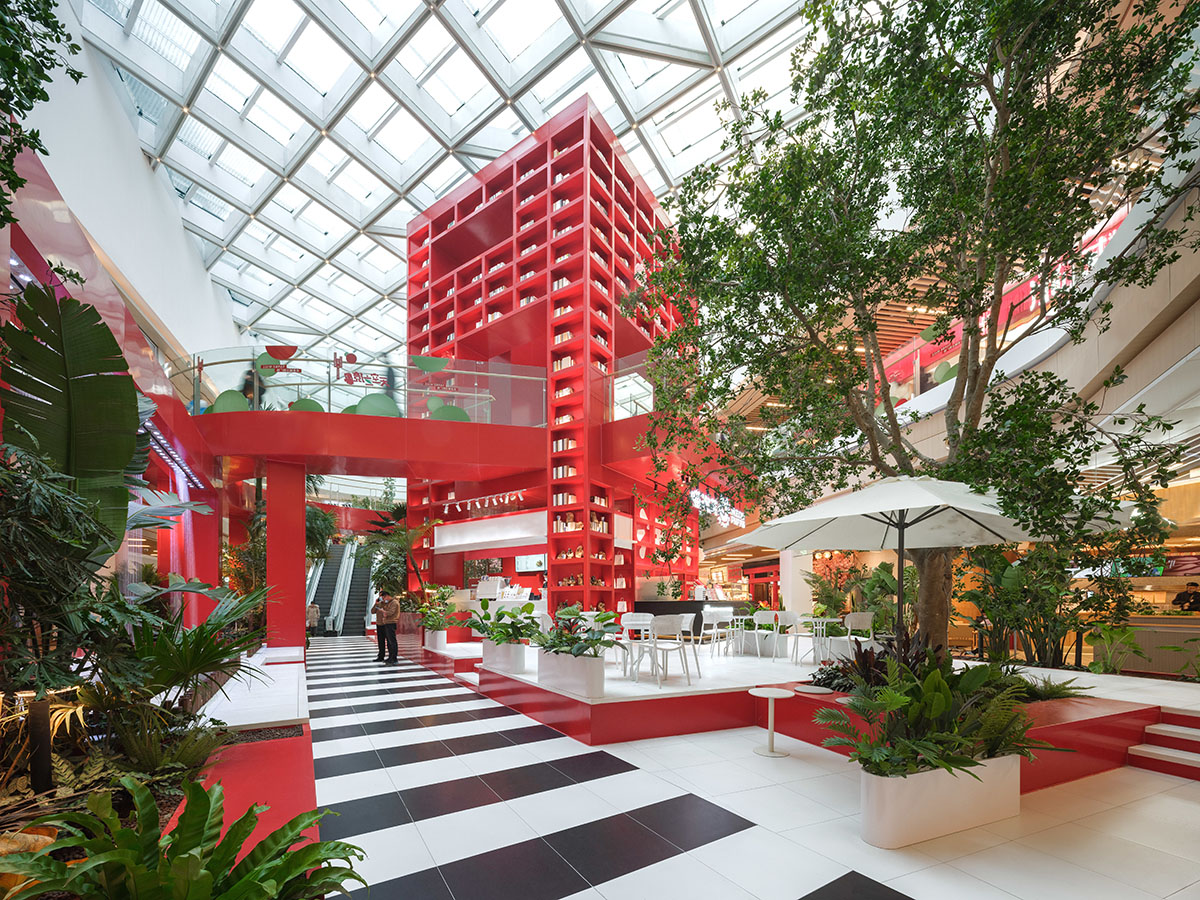 CLOU architects adds bright reddish cube to atrium to evoke Henri Rousseau’s mysterious paintings 