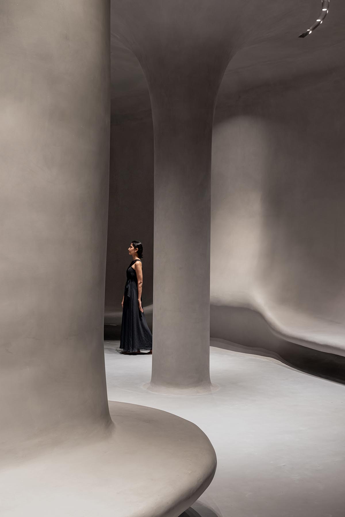 Grey fluid concrete wraps Aatma Manthan Museum by Sanjay Puri Architects