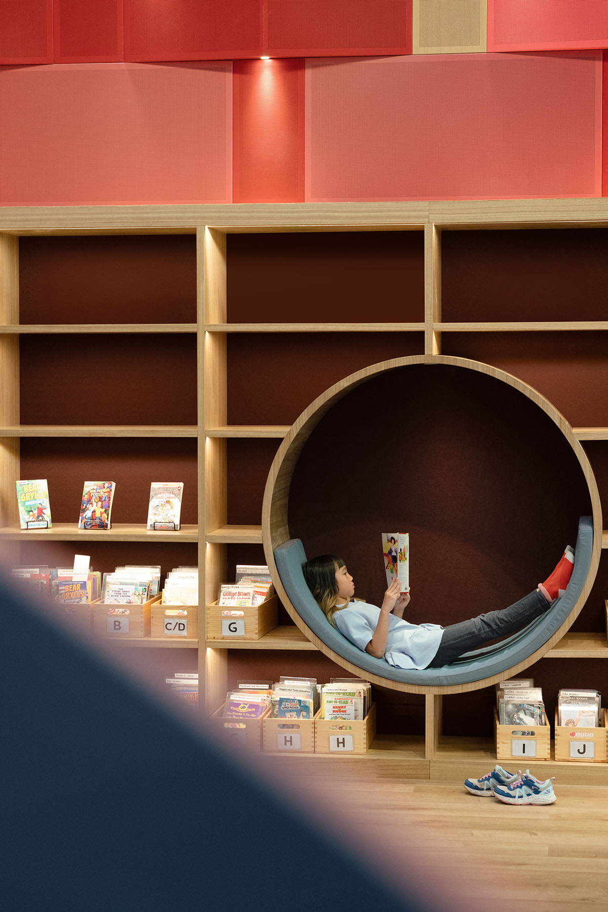 Elementary school library features vibrant colors and playful elements, resembling a fairy tale 