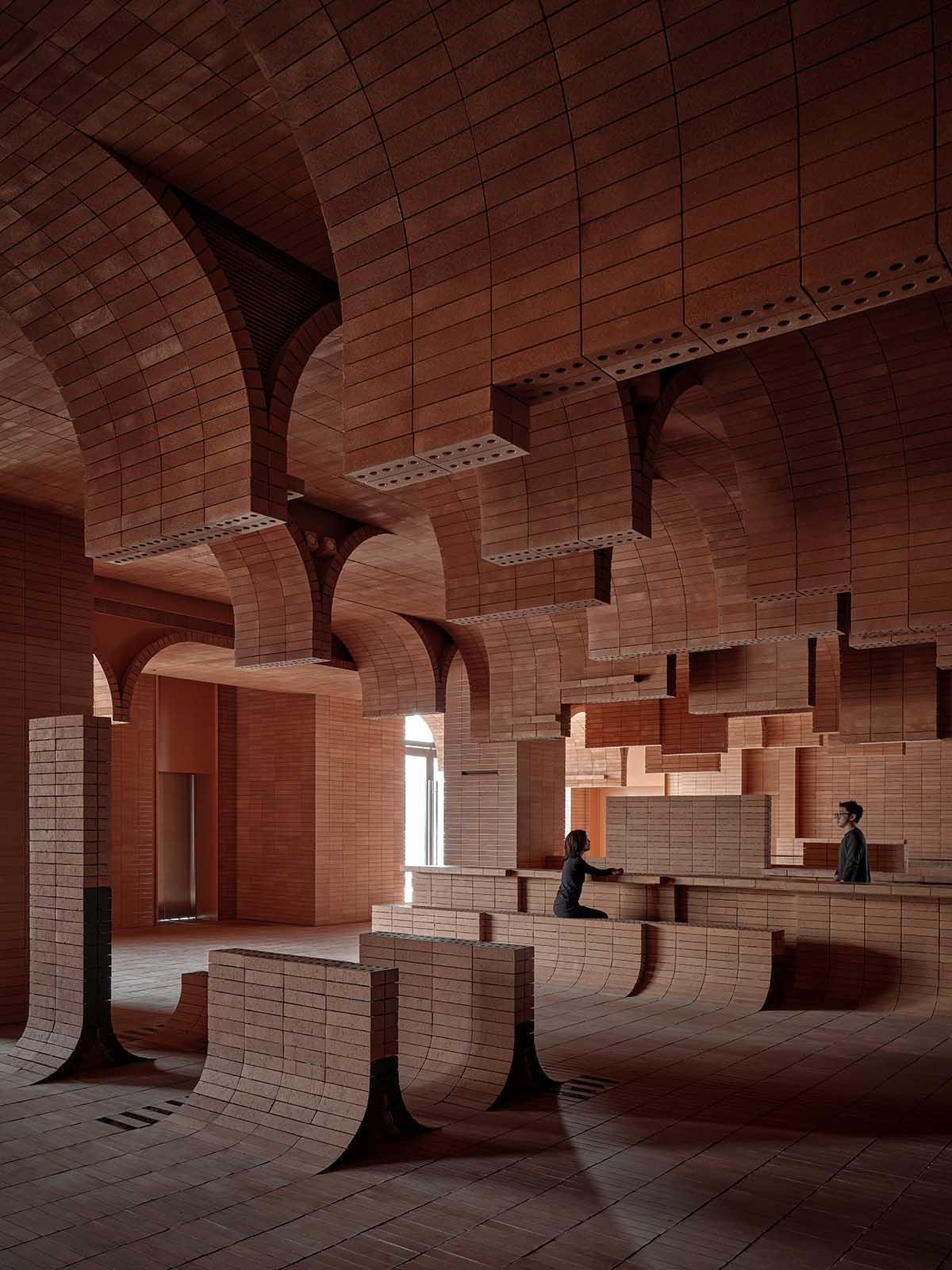 One Plus Partnership adds layered bricks to a cinema interior to resemble waves in Haikou