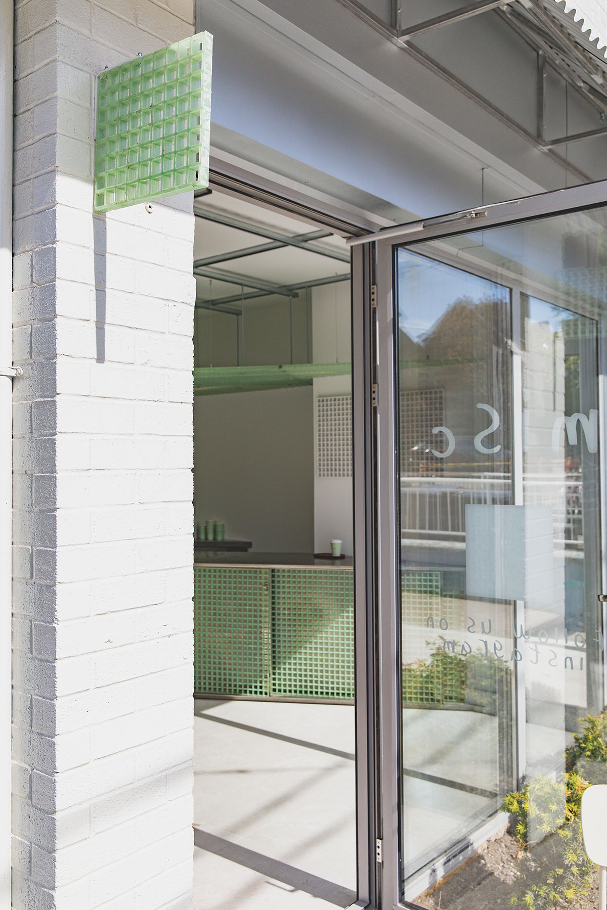 Misc Coffee makes a bold statement with green translucent bar in a busy street of Toronto