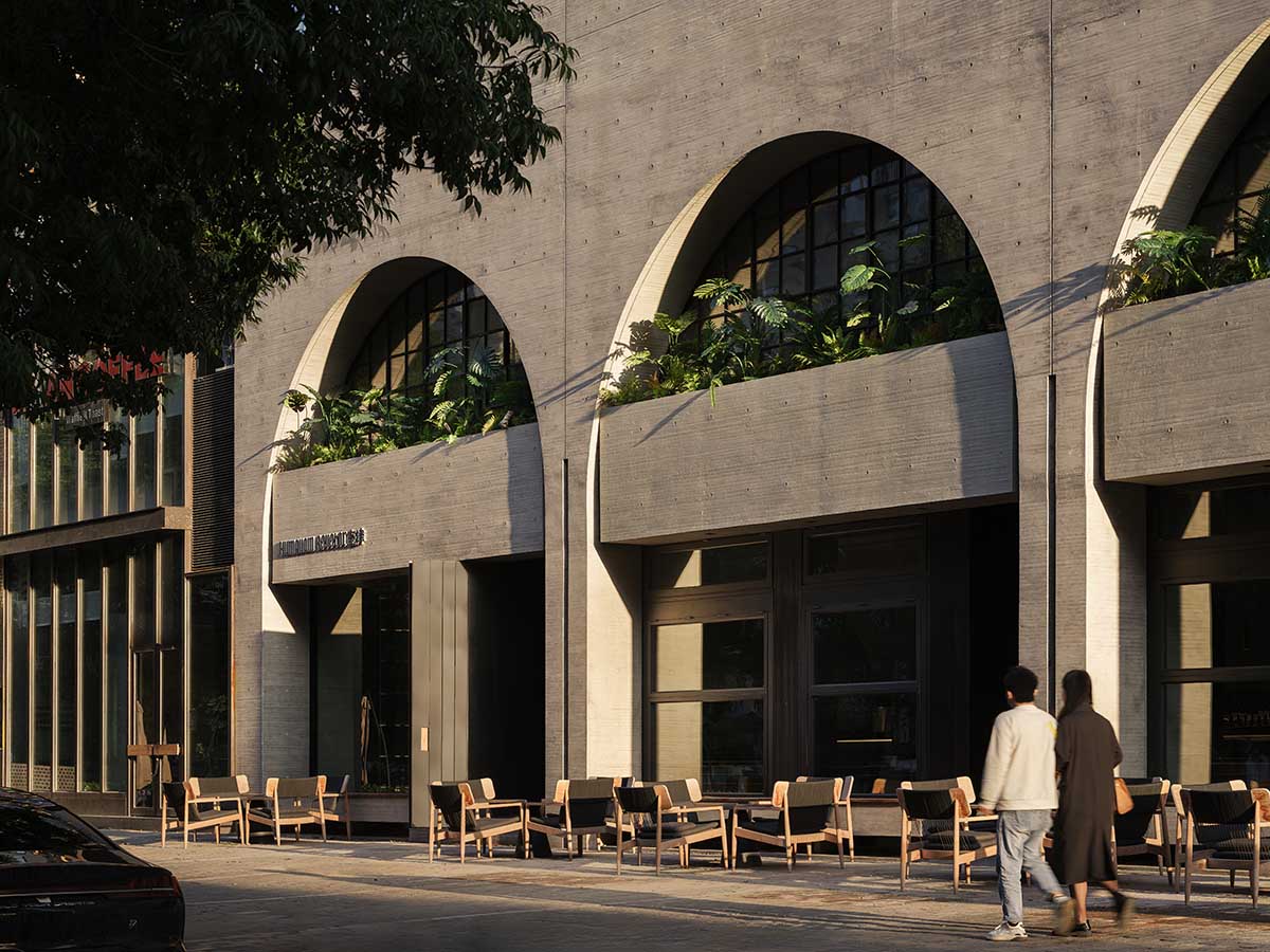 Large triple-arched windows enhance the iconic presence of the concrete Whisky Bar in Taiyuan, China