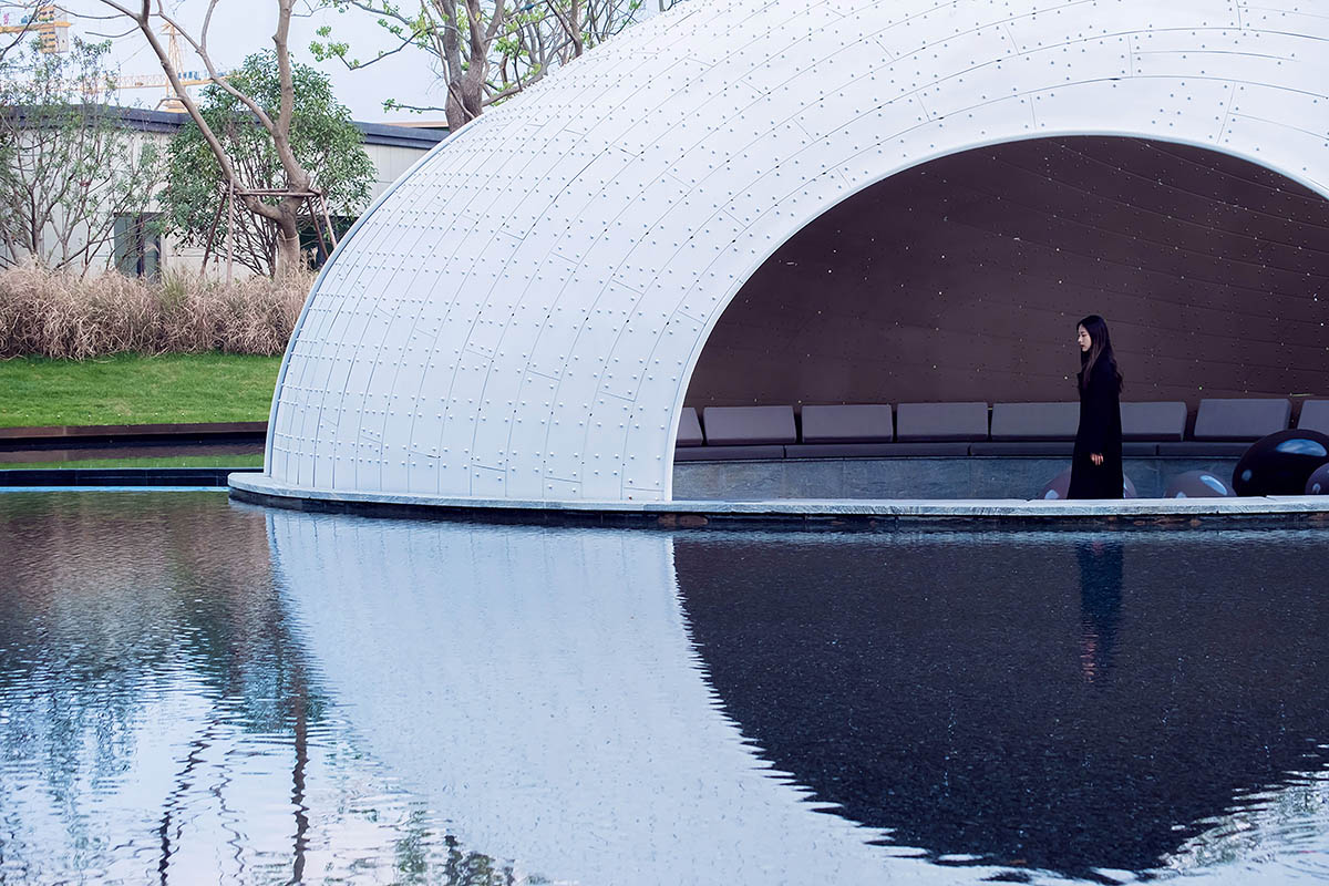   A thin-shell pavilion inspired by the bionic weaving appearance of birds' nests sits on a pool 