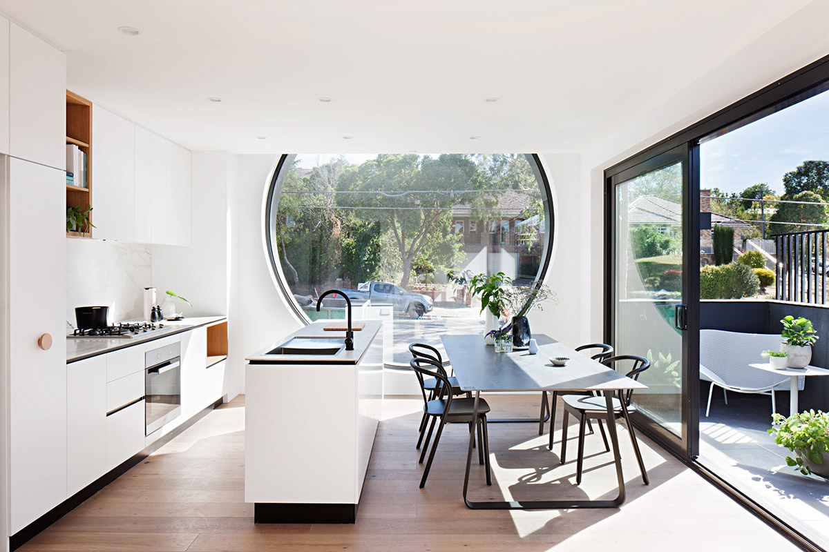 Oversized circular windows dominate the facade of Cirqua Apartments in Melbourne