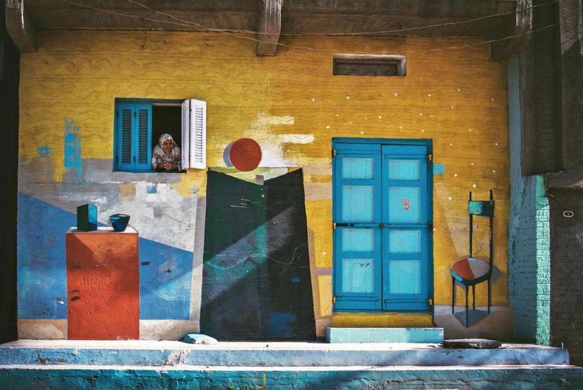 Mona Hassan captures Egyptian Village Festival Houses composed of colourful paintings by 40 artists
