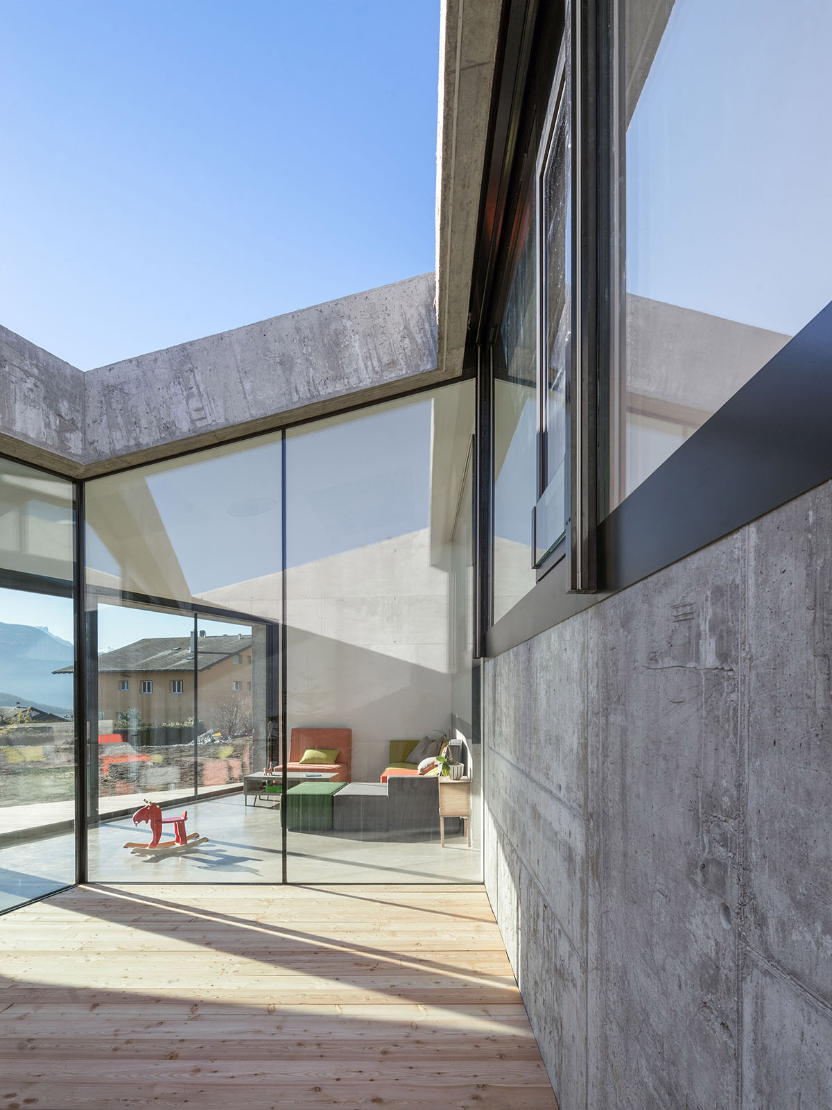 Anako Architecture completes slopped concrete residence in Switzerland