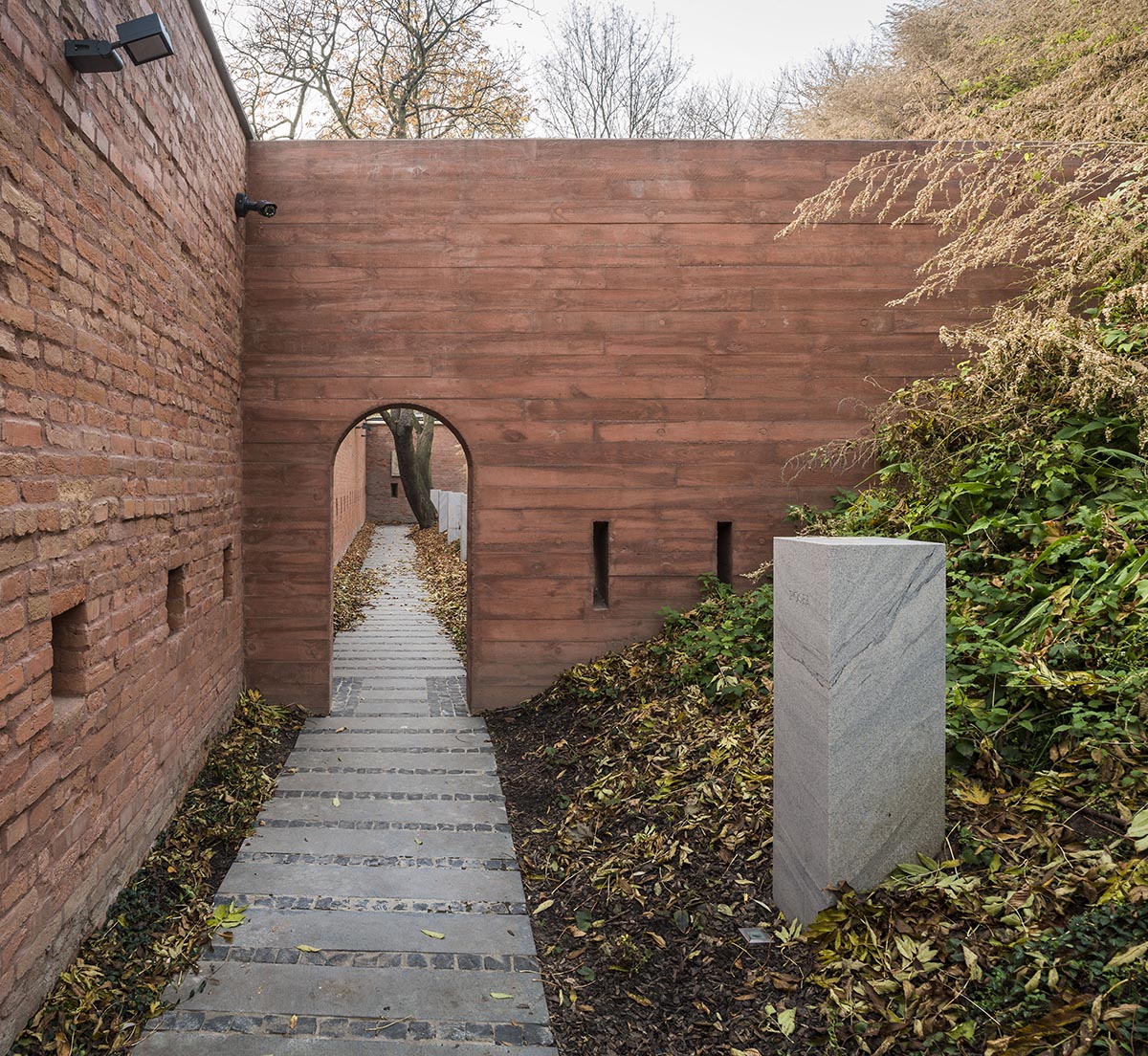 BBGK Architekci designed 12-metre-high stained concrete wall to narrate victims for Katyn Museum