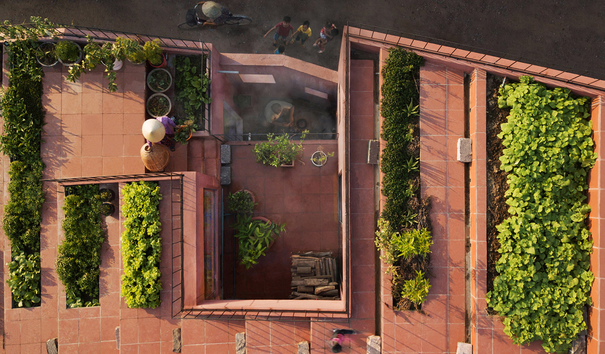 This reddish house features rooftop garden to make owners grow their own food in Vietnam