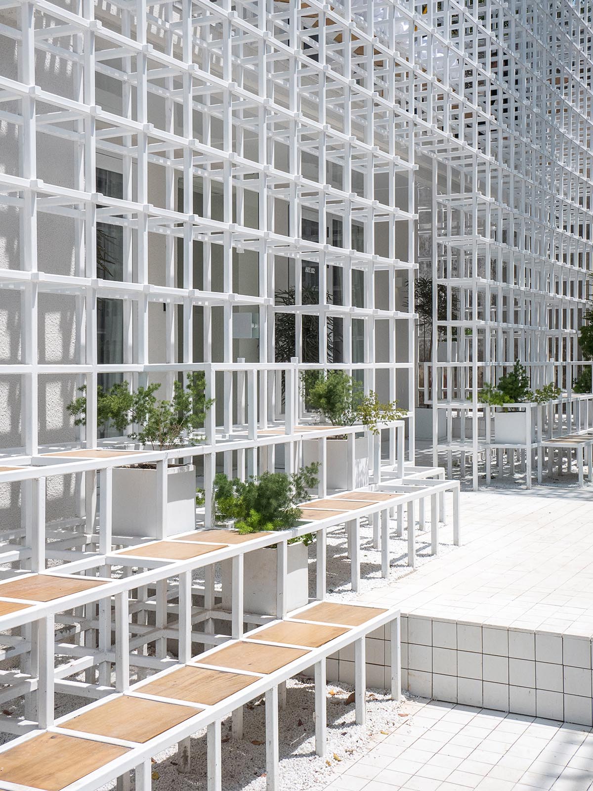 Aether Architects converted old village house into a local hostel by wrapping with structural lattice