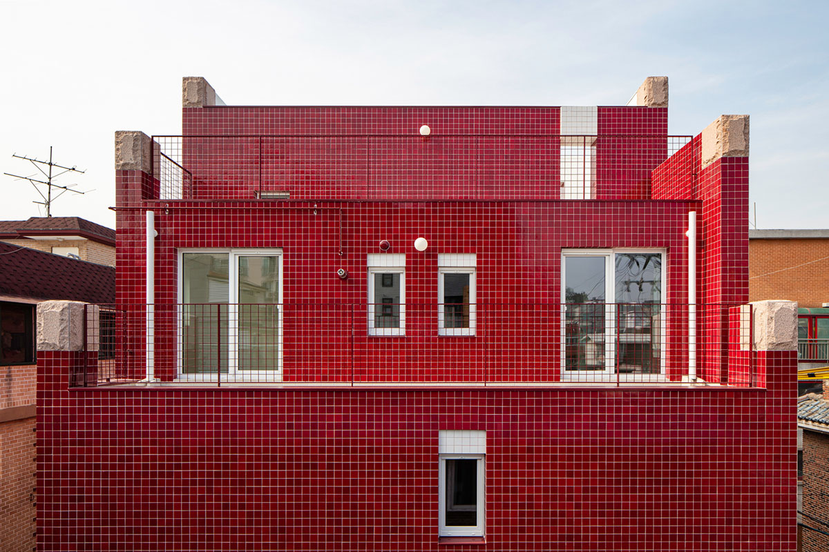 aoa architects uses red marble tiles to clad this apartment in South Korean neighborhood