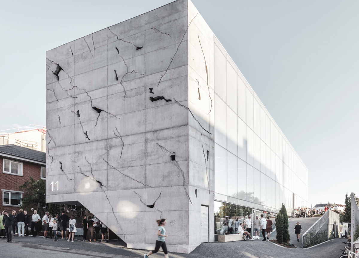 A collage of elements reflecting surroundings assembled on the facade of Office Building by SLETH