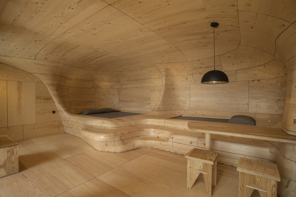 Tenon Architecture creates cave-like wooden interior for a resort in Greece