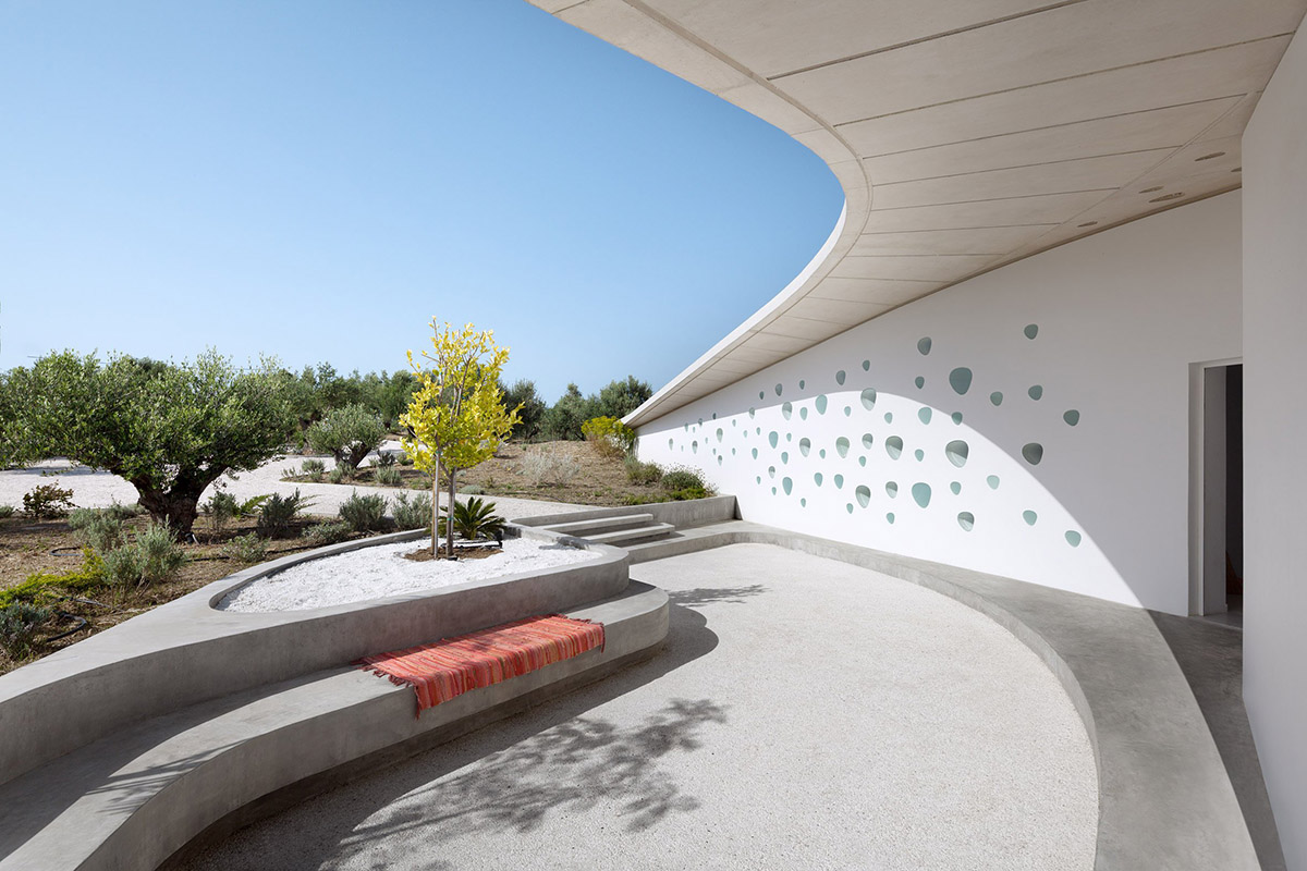 Ypsilon summer house embedded in landscape overlooking Peloponnese’s olive grove