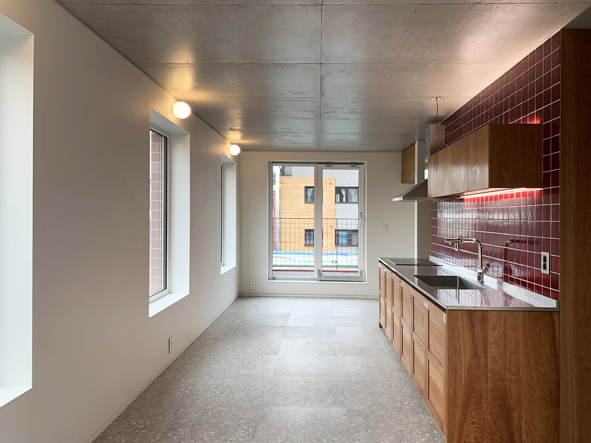 aoa architects uses red marble tiles to clad this apartment in South Korean neighborhood