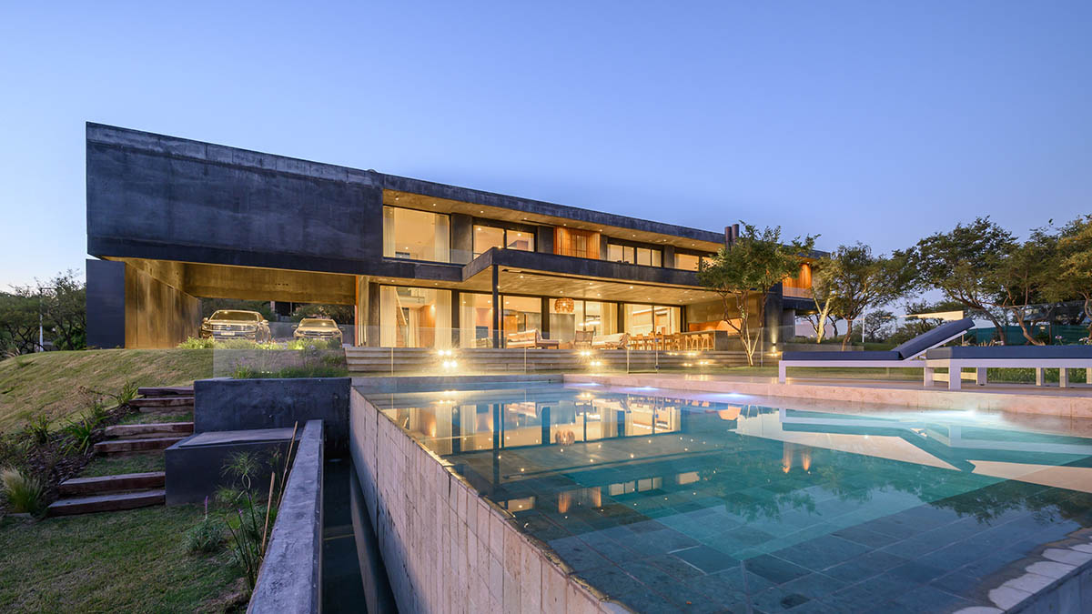 AR Arquitectos completes family home with black concrete and wooden cladding in Argentina 
