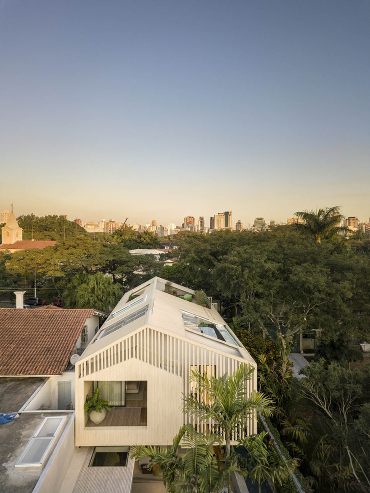 Studio AG designed large wooden residence featuring punctured volumes with gabled roof in São Paulo