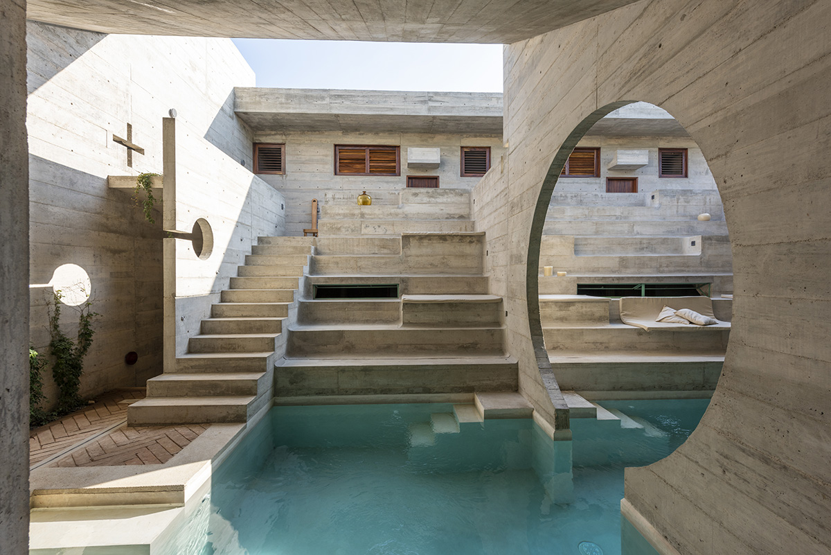 Casa TO by Ludwig Godefroy features an island of stairs and vaulted volumes to create discreet oasis