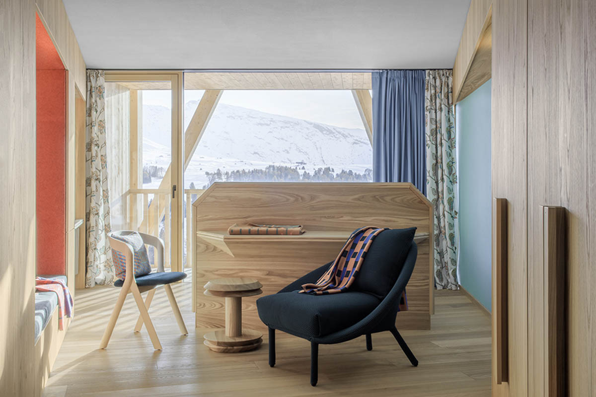 Icaro Hotel featuring wooden colonnade frames embraces alpine heritage landscape in Italy 