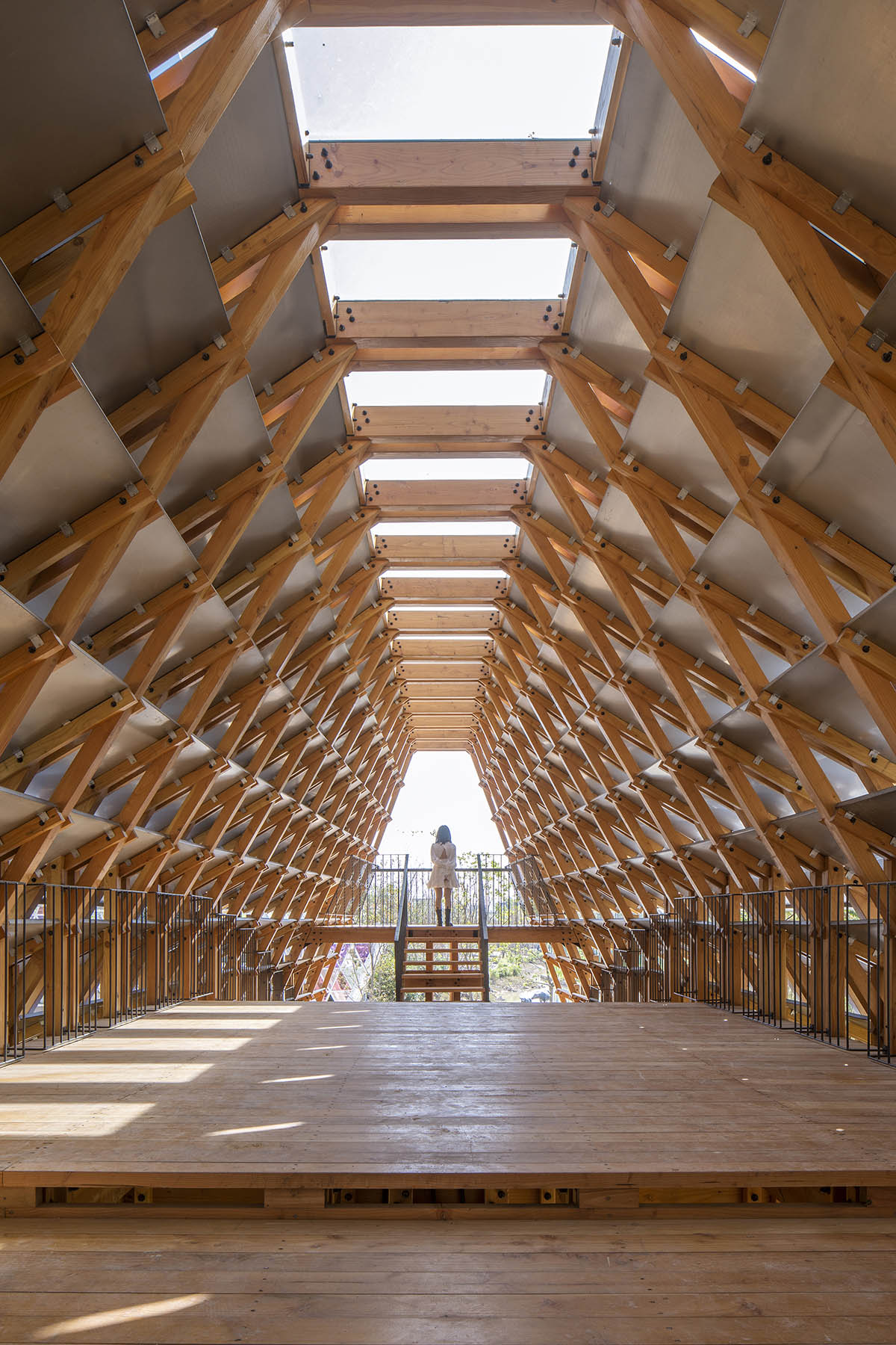 Arched timber bridge by LUO studio allows boats to pass under bridge smoothly in Gulou waterfront
