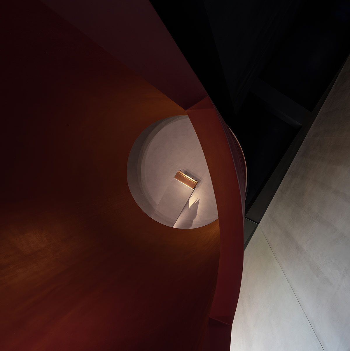 Masanori Designs' interiors include red cylinder bringing rainwater into the space