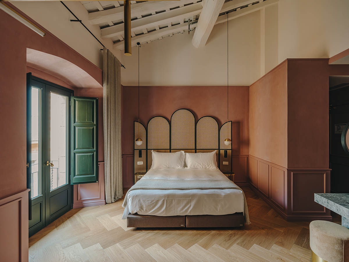 El Equipo Creativo converts 18th-century palace into hotel with rich textures and colors in Girona