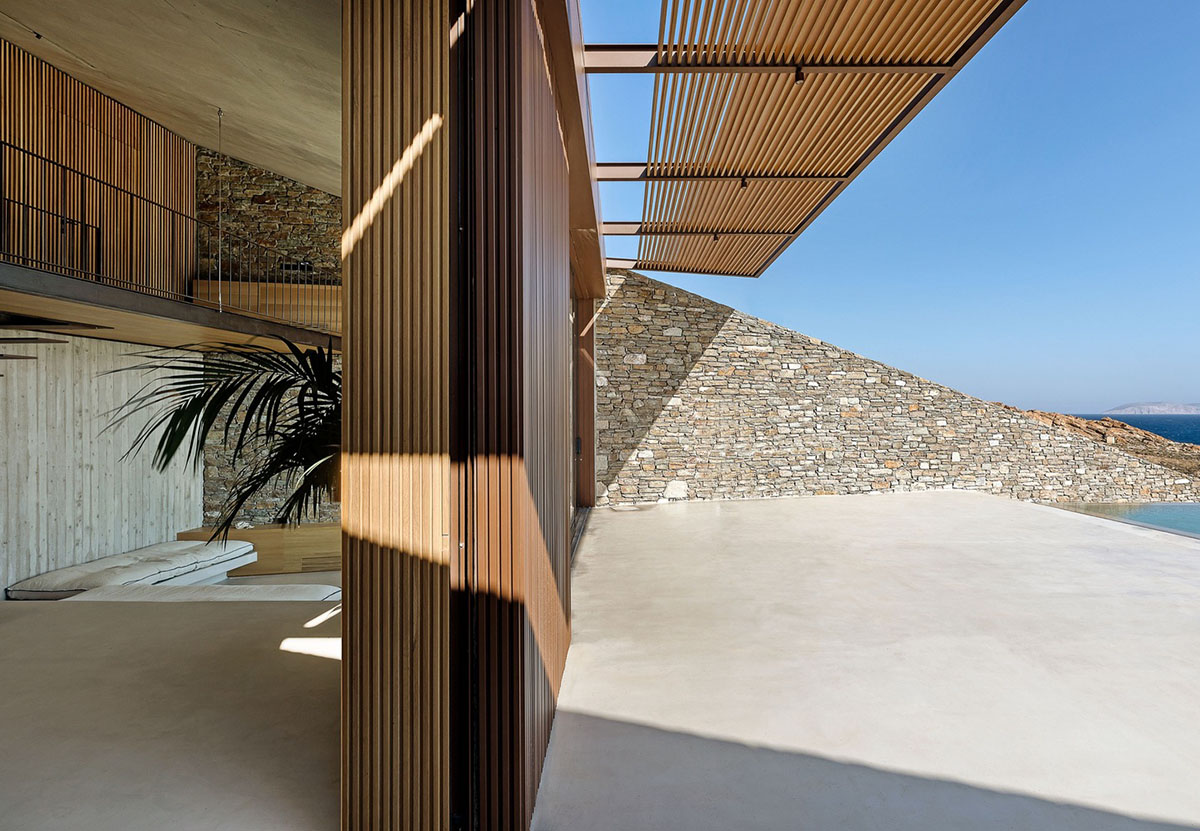 MOLD Architects used advantages of sloping land to design Ncaved house in Greece