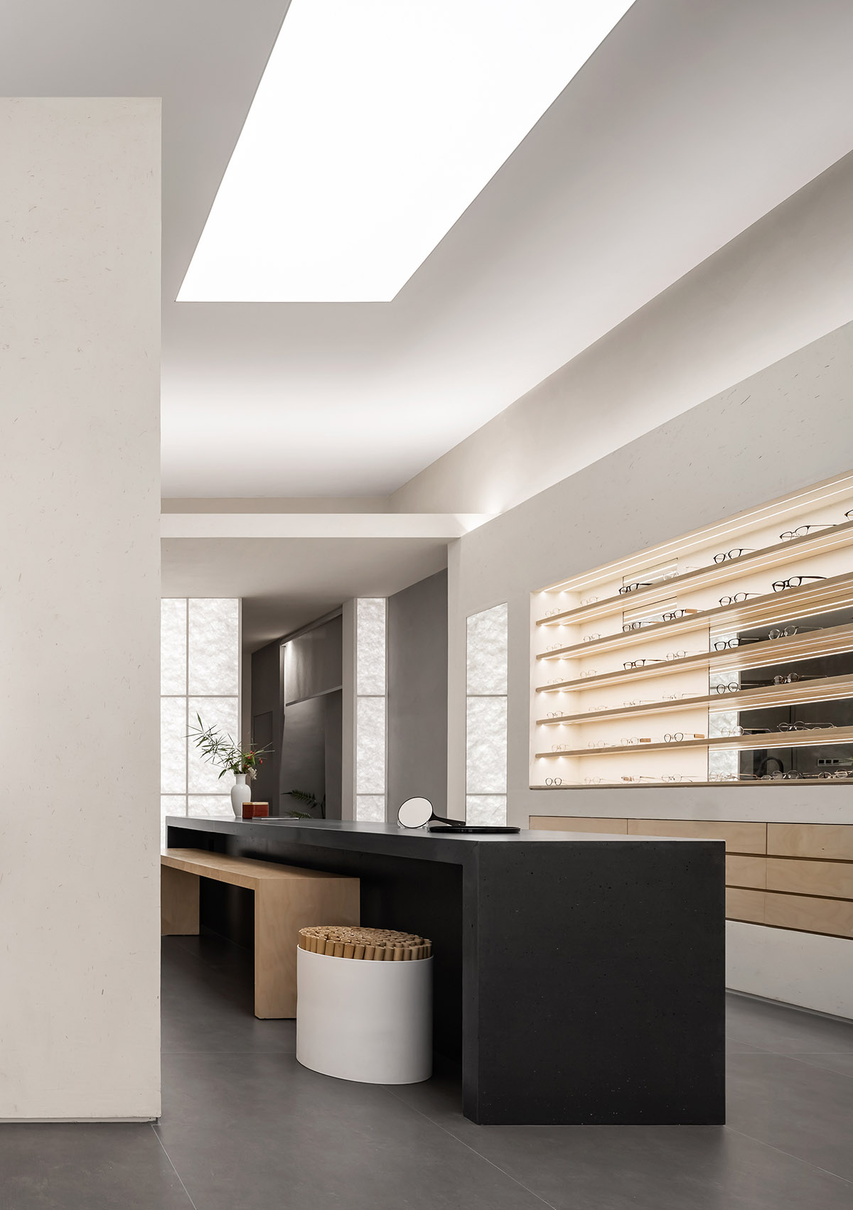 Luminous screen walls create fluid interiors for an optic store designed by Onexn Architects 