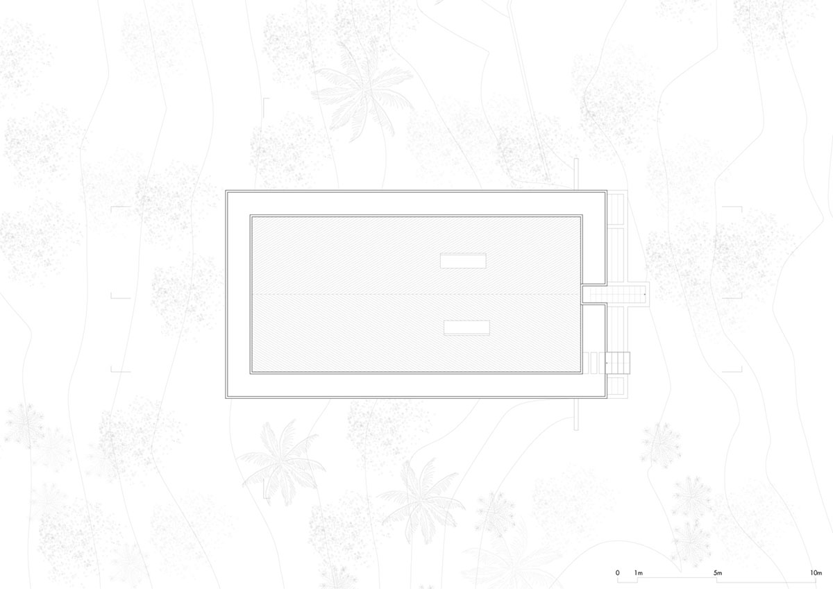 Two bold concrete platforms define this transparent library house by Atelier Branco Arquitetura